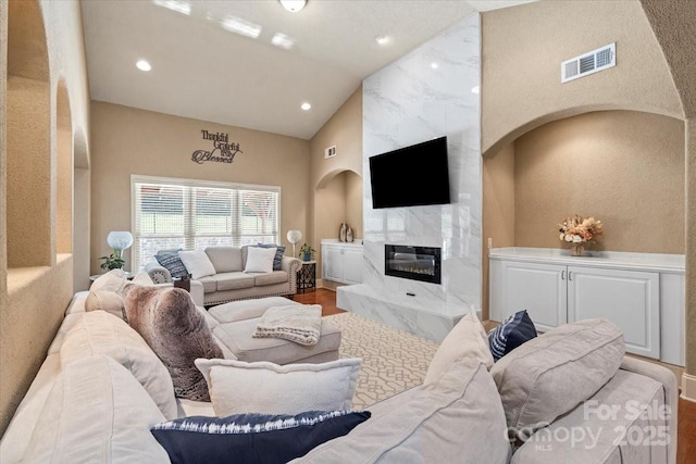 1974 Glen Manor Ct, Lincolnton, NC 28092 - living area with wood finished floors, a premium fireplace, recessed lighting, high vaulted ceiling, and arched walkways