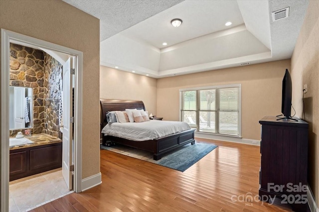 1974 Glen Manor Ct, Lincolnton, NC 28092 - bedroom with light wood-type flooring, a raised ceiling, and baseboards