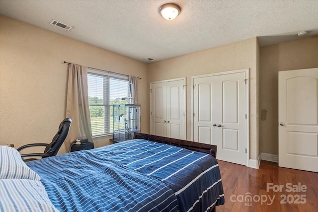 1974 Glen Manor Ct, Lincolnton, NC 28092 - bedroom with wood finished floors, a textured ceiling, baseboards, and two closets