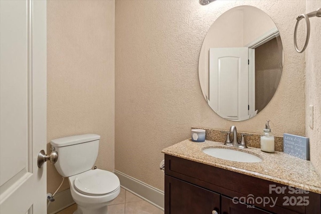 1974 Glen Manor Ct, Lincolnton, NC 28092 - bathroom featuring tile patterned floors, toilet, vanity, baseboards, and a textured wall