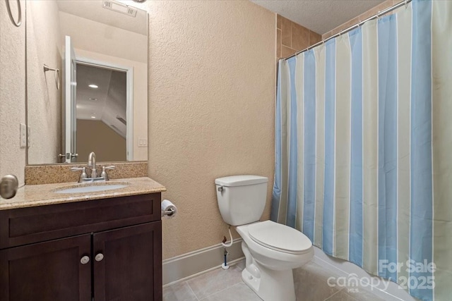 1974 Glen Manor Ct, Lincolnton, NC 28092 - full bath with tile patterned floors, toilet, vanity, a textured wall, and baseboards