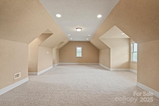 1974 Glen Manor Ct, Lincolnton, NC 28092 - additional living space with a textured ceiling, light carpet, lofted ceiling, recessed lighting, and baseboards