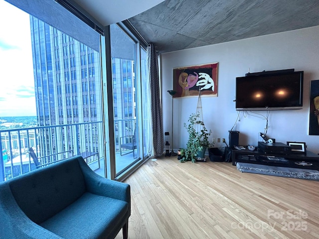 210 N Church St, Charlotte, NC 28202 - living area with plenty of natural light, wood finished floors, and a wall of windows