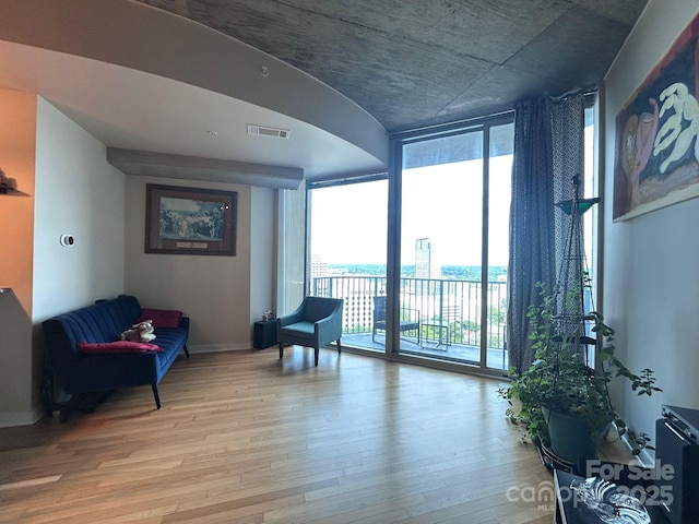 210 N Church St, Charlotte, NC 28202 - living area with floor to ceiling windows, light wood-type flooring, and baseboards
