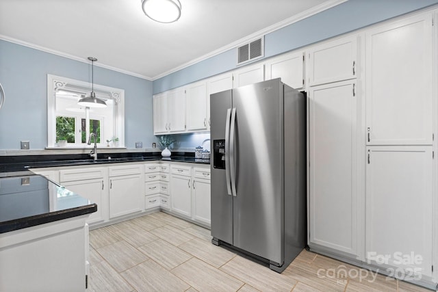 220 Pinehurst Ln, Newton, NC 28658 - kitchen with stainless steel fridge, a sink, crown molding, white cabinetry, and dark countertops