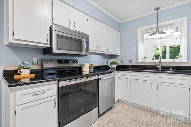 220 Pinehurst Ln, Newton, NC 28658 - kitchen featuring appliances with stainless steel finishes, a sink, white cabinets, dark countertops, and crown molding