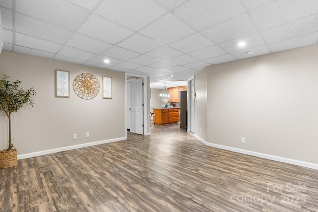 220 Pinehurst Ln, Newton, NC 28658 - unfurnished living room with dark wood-style flooring, baseboards, a paneled ceiling, and recessed lighting