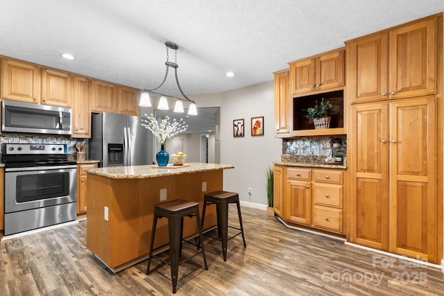 220 Pinehurst Ln, Newton, NC 28658 - kitchen featuring appliances with stainless steel finishes, tasteful backsplash, a kitchen island, dark wood-style flooring, and recessed lighting