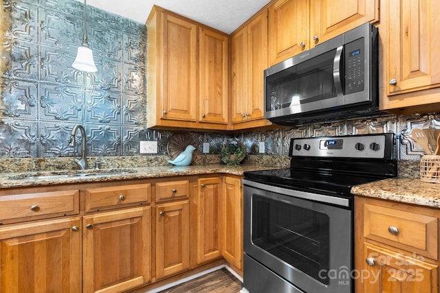 220 Pinehurst Ln, Newton, NC 28658 - kitchen with appliances with stainless steel finishes, a sink, decorative backsplash, light stone countertops, and dark wood finished floors