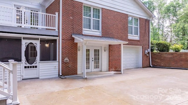 220 Pinehurst Ln, Newton, NC 28658 - view of front of home with french doors, brick siding, a balcony, a garage, and driveway