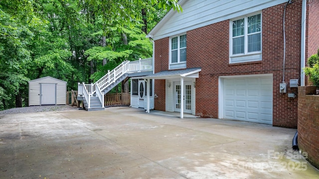 220 Pinehurst Ln, Newton, NC 28658 - view of front facade with stairway, an attached garage, concrete driveway, a storage unit, and brick siding