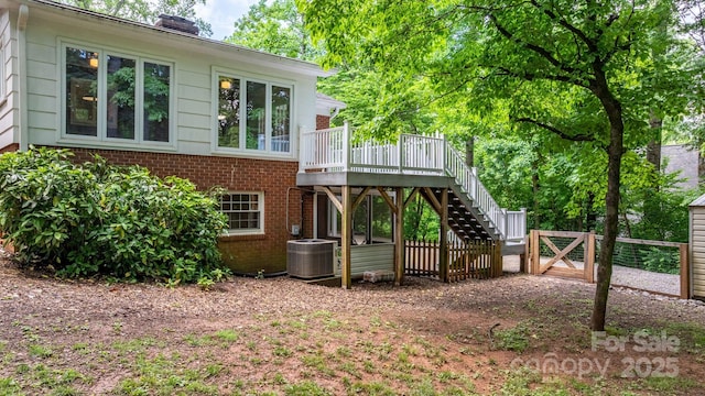 220 Pinehurst Ln, Newton, NC 28658 - rear view of house with brick siding, central air condition unit, stairs, a wooden deck, and fence