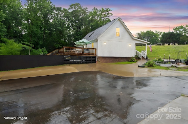 1135 Brook Path Trl, Denver, NC 28037 - property exterior at dusk featuring a wooden deck and fence