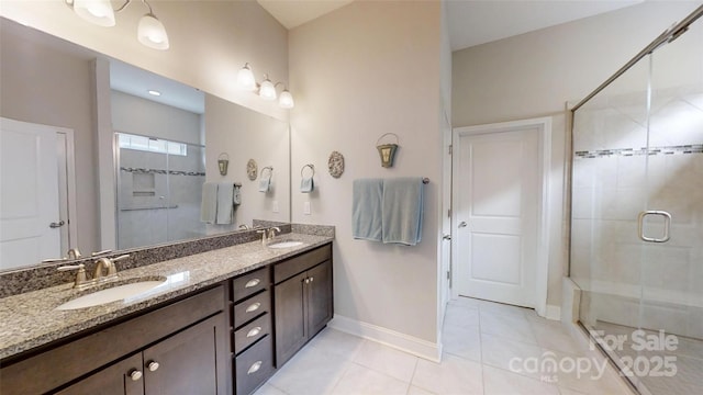 123 Hanks Bluff Dr, Mooresville, NC 28117 - full bathroom featuring a shower stall, double vanity, baseboards, and tile patterned floors