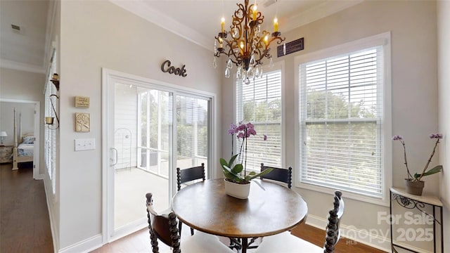 123 Hanks Bluff Dr, Mooresville, NC 28117 - dining space featuring healthy amount of natural light, a chandelier, wood finished floors, and crown molding