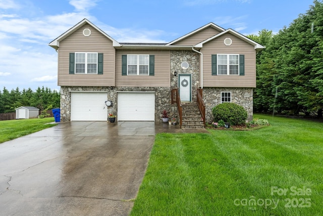raised ranch featuring stone siding, a garage, driveway, and a front lawn