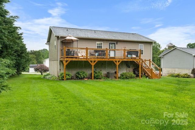 back of property with a wooden deck, central AC unit, stairs, and a lawn