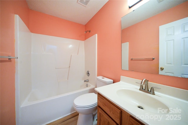bathroom with toilet, vanity, shower / washtub combination, and wood finished floors