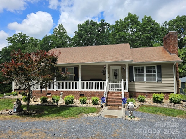 490 Deberry Rd, Mount Gilead, NC 27306 - ranch-style house with a chimney, a porch, and a shingled roof