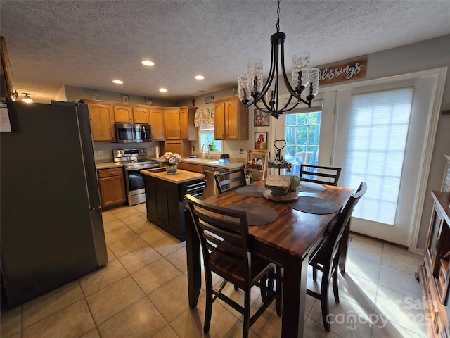490 Deberry Rd, Mount Gilead, NC 27306 - dining space with a chandelier, light tile patterned flooring, recessed lighting, and a textured ceiling