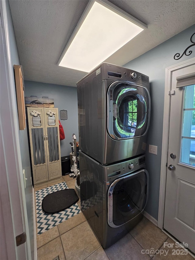 490 Deberry Rd, Mount Gilead, NC 27306 - laundry area with stacked washer / dryer, tile patterned floors, and a textured ceiling