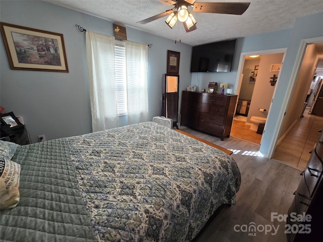490 Deberry Rd, Mount Gilead, NC 27306 - bedroom with wood finished floors, a textured ceiling, a ceiling fan, and connected bathroom