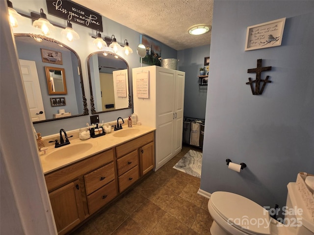 490 Deberry Rd, Mount Gilead, NC 27306 - bathroom featuring toilet, a textured ceiling, and double vanity