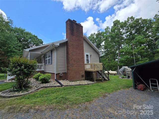 490 Deberry Rd, Mount Gilead, NC 27306 - view of side of home with a yard, stairs, a chimney, a deck, and crawl space