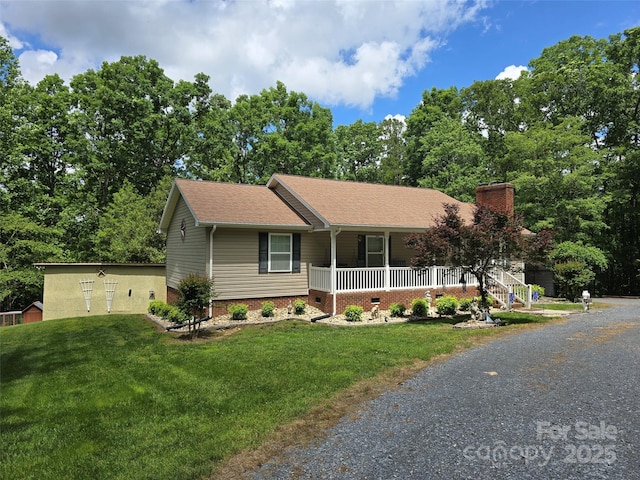 490 Deberry Rd, Mount Gilead, NC 27306 - single story home featuring covered porch, a front lawn, a chimney, roof with shingles, and driveway