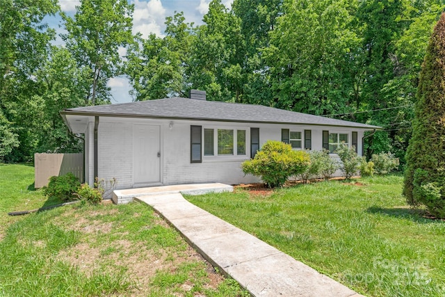 518 Westside Cir, China Grove, NC 28023 - single story home with a front lawn, a chimney, and brick siding
