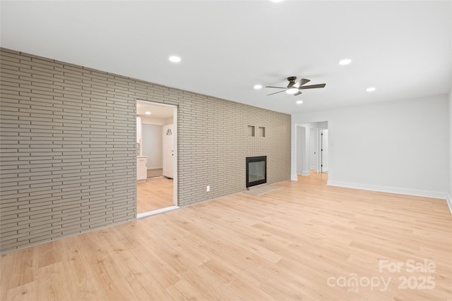 518 Westside Cir, China Grove, NC 28023 - unfurnished living room featuring a ceiling fan, light wood-style flooring, brick wall, a fireplace, and recessed lighting