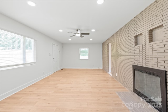 518 Westside Cir, China Grove, NC 28023 - unfurnished living room featuring recessed lighting, a ceiling fan, a brick fireplace, brick wall, and baseboards