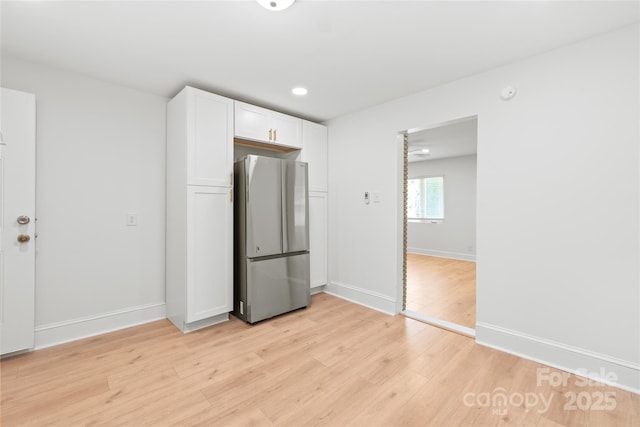 518 Westside Cir, China Grove, NC 28023 - kitchen with freestanding refrigerator, white cabinetry, light wood-style flooring, baseboards, and recessed lighting