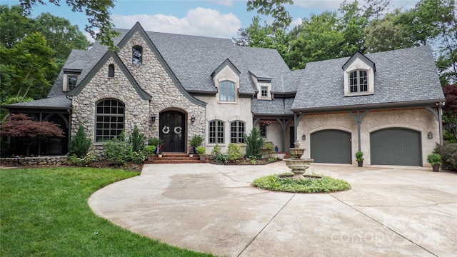 5523 Meadow Haven Ln, Charlotte, NC 28270 - french provincial home featuring stone siding, curved driveway, a front yard, and a high end roof