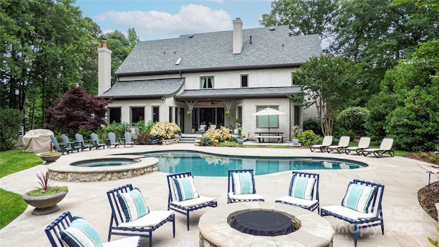 5523 Meadow Haven Ln, Charlotte, NC 28270 - view of swimming pool with an outdoor fire pit, a patio area, a grill, and a pool with connected hot tub