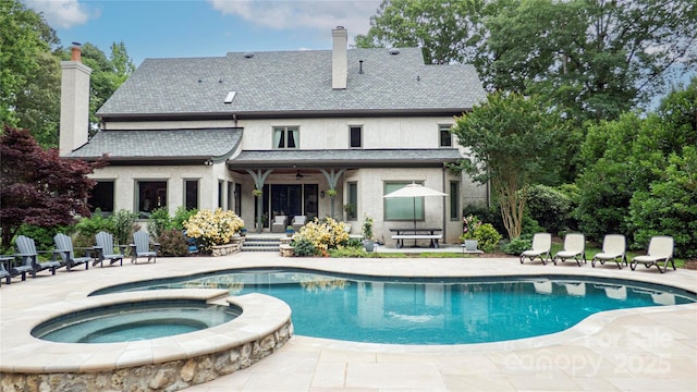 5523 Meadow Haven Ln, Charlotte, NC 28270 - back of property featuring a chimney, a patio area, a ceiling fan, and a pool with connected hot tub