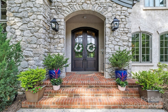 5523 Meadow Haven Ln, Charlotte, NC 28270 - view of exterior entry featuring stone siding, french doors, and stucco siding