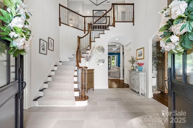 5523 Meadow Haven Ln, Charlotte, NC 28270 - foyer featuring arched walkways, stairs, a high ceiling, and baseboards
