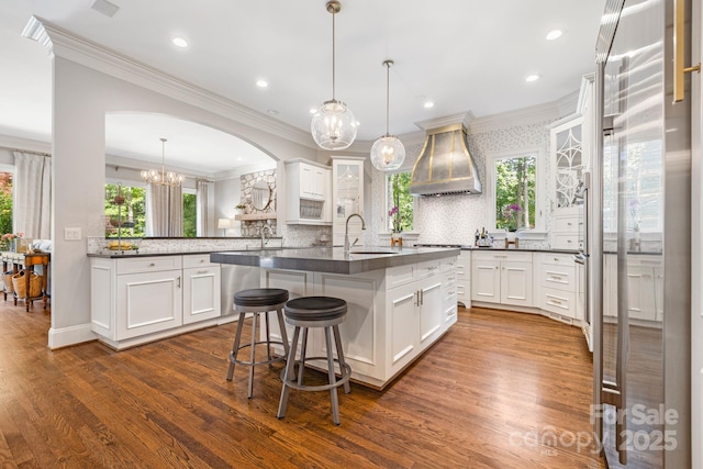 5523 Meadow Haven Ln, Charlotte, NC 28270 - kitchen featuring premium range hood, ornamental molding, dark countertops, a sink, and dark wood-style floors