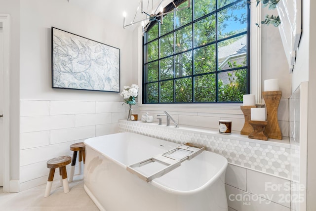 5523 Meadow Haven Ln, Charlotte, NC 28270 - bathroom with a soaking tub, tile walls, tile patterned floors, and wainscoting