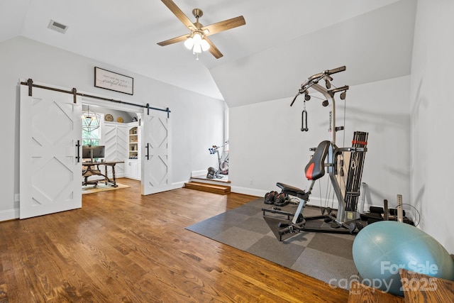 5523 Meadow Haven Ln, Charlotte, NC 28270 - exercise area featuring a barn door, vaulted ceiling, a ceiling fan, baseboards, and wood finished floors