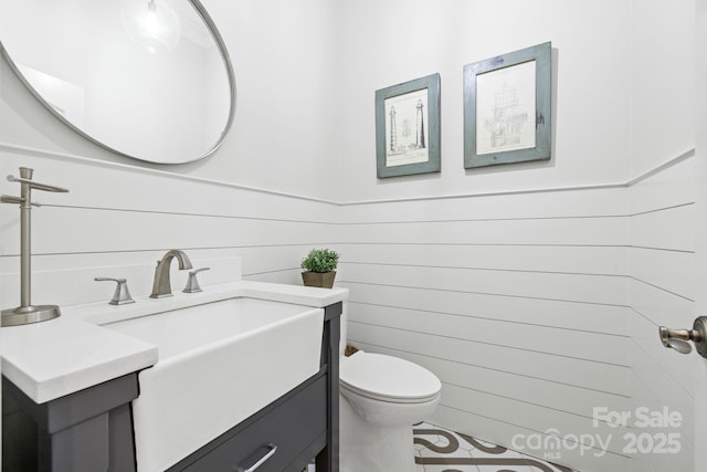 5523 Meadow Haven Ln, Charlotte, NC 28270 - bathroom featuring vanity, toilet, tile patterned flooring, and wooden walls