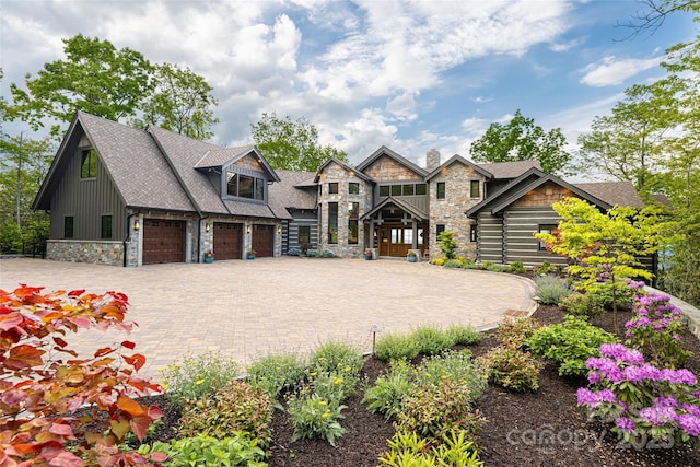 511 Asgi Trl, Maggie Valley, NC 28751 - view of front facade featuring stone siding, decorative driveway, and board and batten siding