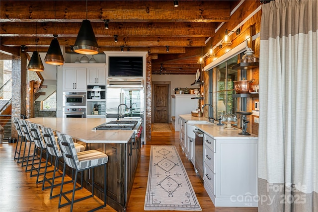 511 Asgi Trl, Maggie Valley, NC 28751 - kitchen with wood finished floors, beamed ceiling, open shelves, and healthy amount of natural light