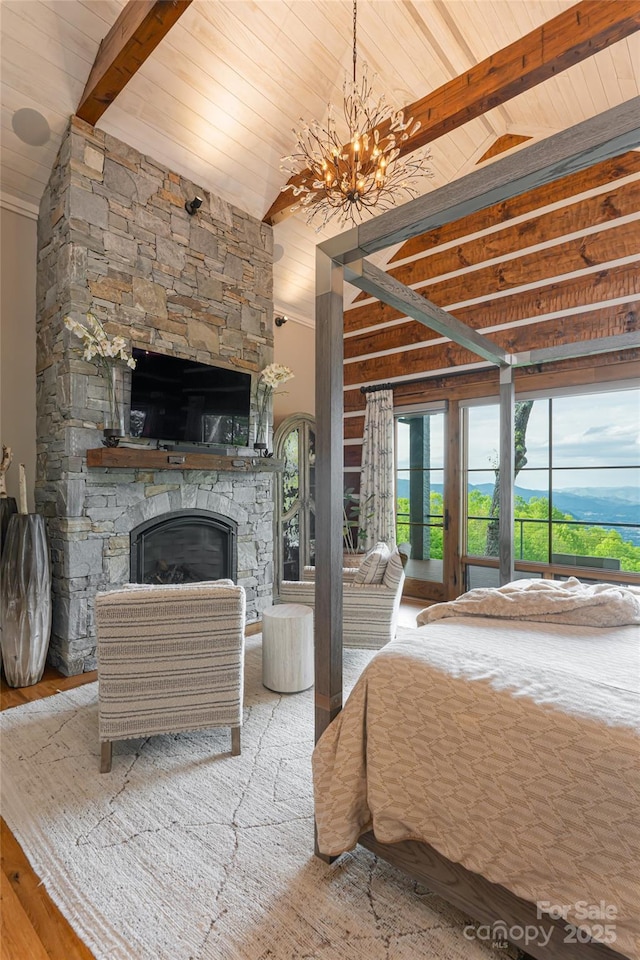 511 Asgi Trl, Maggie Valley, NC 28751 - bedroom featuring wood ceiling, access to outside, a chandelier, a stone fireplace, and wood finished floors