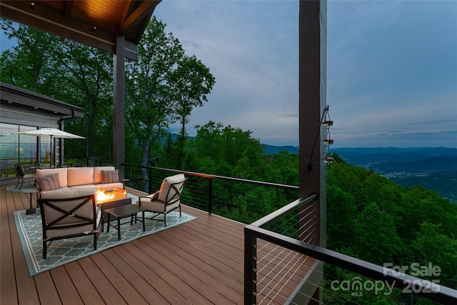 511 Asgi Trl, Maggie Valley, NC 28751 - deck with an outdoor living space with a fire pit, a mountain view, and a forest view