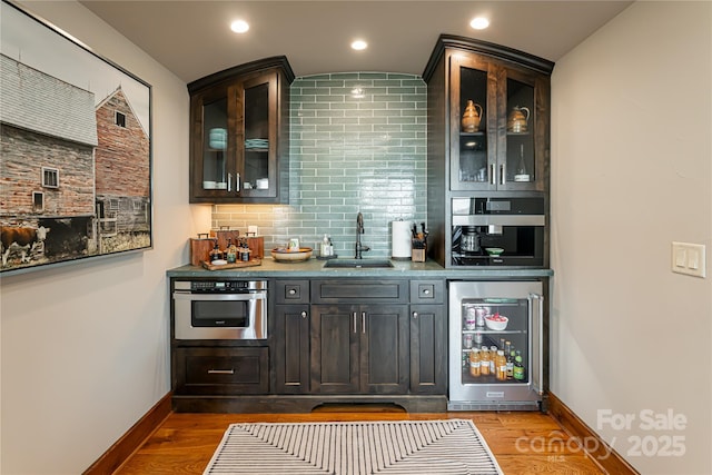 511 Asgi Trl, Maggie Valley, NC 28751 - indoor wet bar with wine cooler, oven, dark wood-style flooring, baseboards, and recessed lighting