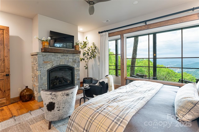 511 Asgi Trl, Maggie Valley, NC 28751 - bedroom with wood finished floors, a fireplace, access to exterior, and ceiling fan