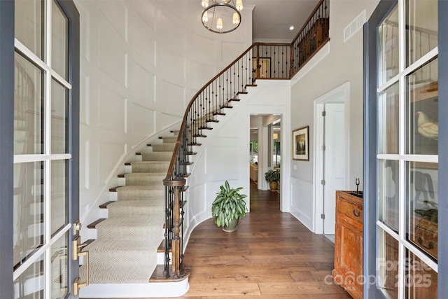 2630 Mary Butler Way, Charlotte, NC 28226 - entryway with a decorative wall, a towering ceiling, stairway, wood finished floors, and french doors