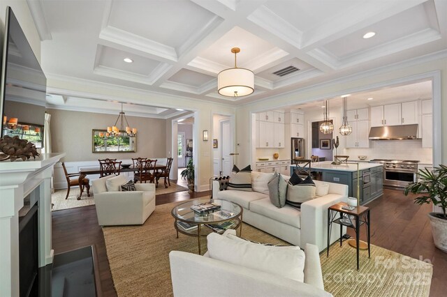 2630 Mary Butler Way, Charlotte, NC 28226 - living area featuring dark wood finished floors, a chandelier, ornamental molding, beam ceiling, and coffered ceiling